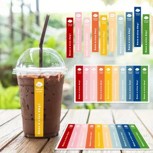 Detailed view of colorful sealing stickers with Thank You message on a plastic coffee cup