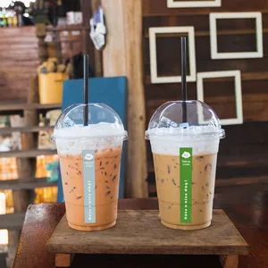 Detailed view of colorful thank you sealing stickers on iced coffee cups.