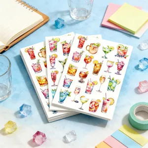 Detail view of summer drink watercolor stickers on a desk with scrapbooking supplies