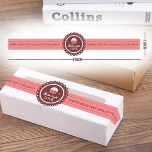 Détail des bandes autocollantes de scellage rose 9x1 pouces sur une boîte à gâteaux.