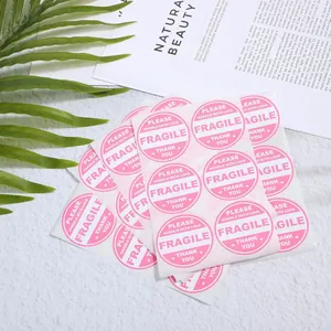 Close-up detail of Fragile shipping stickers with Handle With Love and Thank You text