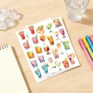 Detail shot of watercolor summer drink stickers on a wooden desk with stationery