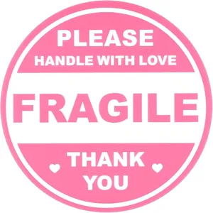 Detail of pink round fragile shipping sticker with Handle with Love text