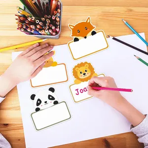 Writing a name on a cute fox and lion themed self-adhesive label sticker for kids