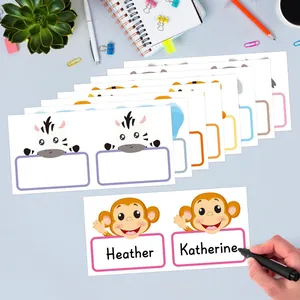 Close-up of colorful cartoon animal name stickers being written on with a black pen.
