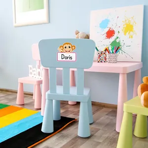 Detail view showing a cute monkey animal name label sticker on a blue plastic chair