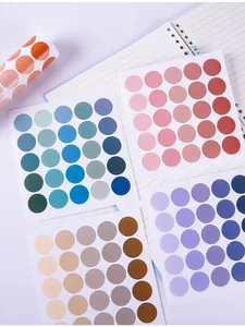 Close-up detail of Morandi color dot stickers neatly arranged on a spiral notebook