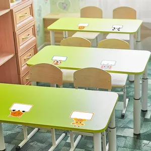 Cartoon animal name label stickers displayed on green classroom desks for back to school season