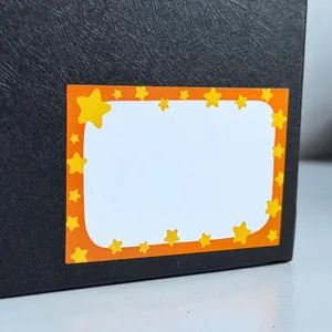 Macro detail of a cartoon star name label sticker on a black textured surface