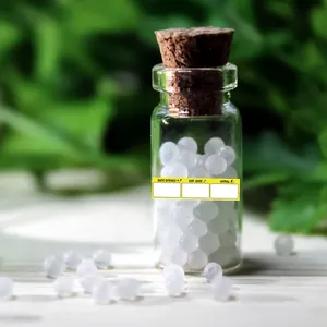 Detailed view of yellow adhesive labels for expiry dates applied on a small glass bottle