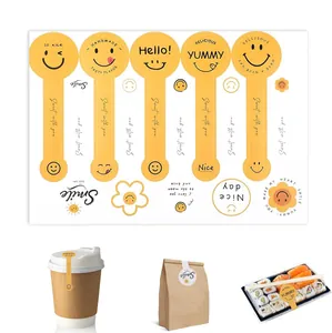 Set of yellow smiley face baking stickers shown on coffee cups and food packaging containers