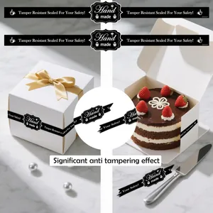 Black tamper resistant long sealing stickers shown applied on a white cake box and gift packaging