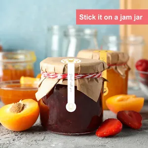 Yellow smiley face decorative sealing stickers applied to a homemade jam jar