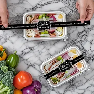 Close-up of black 'Hand made' tamper-evident sealing stickers for food packaging