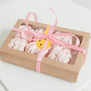 Close-up detail of yellow smiley face decorative sticker sealing a craft gift box