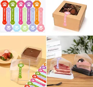 Detail view of cute paw-shaped long stickers on various bakery packaging boxes.