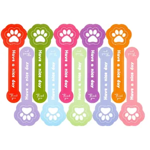 Set of ten colorful dog paw shaped baking stickers with Have a nice day and Thank you text