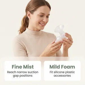 Woman holding breast pump parts showing fine mist and mild foam cleaning benefits