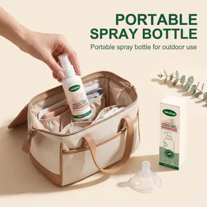 Jakehoe breast pump cleaner spray being placed into a portable storage bag for travel.
