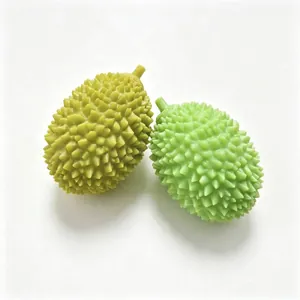 Deux jouets anti-stress en forme de durian dans des tons vert vif et jaune