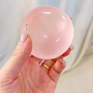Detailed view of hand holding a pink translucent slow rebound stress relief squishy ball