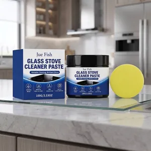 Glass stove cleaner paste with yellow sponge on a bright modern kitchen countertop.