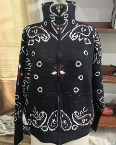 Detailed front view of a black knit zip-up cardigan with white paisley pattern print