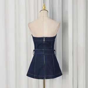Back view of a slim dark blue denim strapless top with belt detail on mannequin
