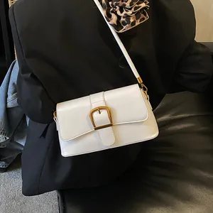 Elegant vintage white baguette handbag with large gold buckle and slim shoulder strap