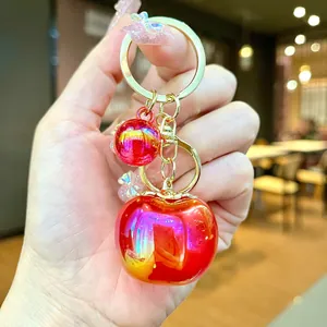 Creative red apple keychain with iridescent finish, elegant fruit charm for bag accessories