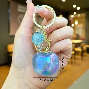Creative apple keychain charm with gradient purple translucent finish and gold ring