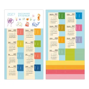 Detalle de pegatinas de calendario 2027 con motivos marinos y pestañas de colores.