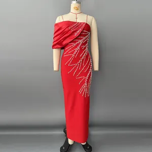 Detailed view of the sparkling rhinestone patterns on an elegant red bandage evening gown