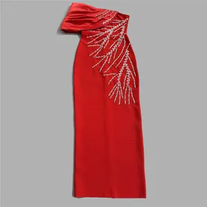 Detailed view of a vibrant red bandage evening gown with silver rhinestone branch embroidery.