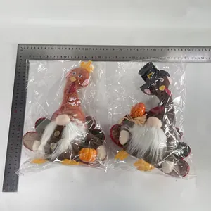 Two Thanksgiving turkey gnome plush dolls in packaging with rulers showing dimensions
