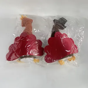 Close-up view of two Thanksgiving turkey plush decorations inside clear plastic packaging