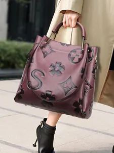 Elegant burgundy leather tote bag with embossed patterns for stylish daily commuting.