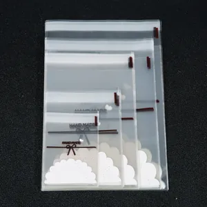 Close-up detail of clear self-sealing jewelry bags featuring a brown bow and Hand Made text