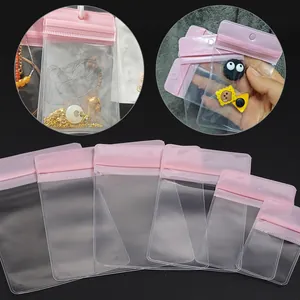 Detailed view of clear pink zip-lock jewelry bags in six different sizes for small accessories
