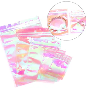 Close-up detail of iridescent holographic ziplock bags for jewelry packaging and storage.