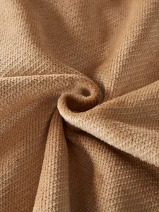Close-up of the soft pineapple grid fleece texture on a warm men's cardigan jacket
