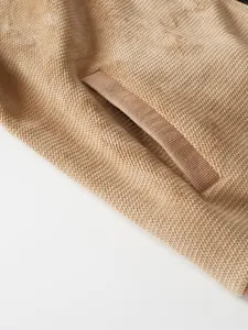 Close-up detail of pineapple grid texture on a thick men's knit cardigan jacket
