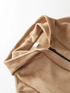 Close-up detail of men's tan pineapple grid hooded zip-up jacket showing texture