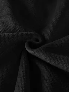Detailed macro view of premium black pineapple grid waffle knit fabric for men's jackets.