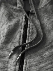 Macro detail of men's grey pineapple lattice fleece hoodie with zip and drawstring