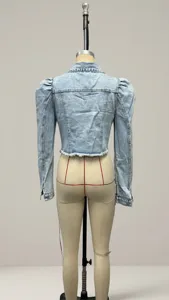 Back view of a cropped light blue denim jacket with puff sleeves on a mannequin.