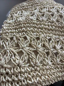 Close-up detail of handcrafted straw woven pattern on minimalist crossbody phone bag