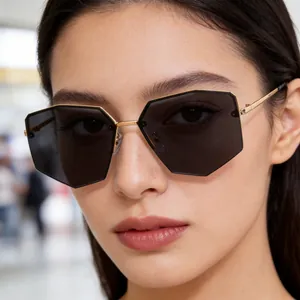 Chic rimless polygonal sunglasses with gold metal temples worn by a female model