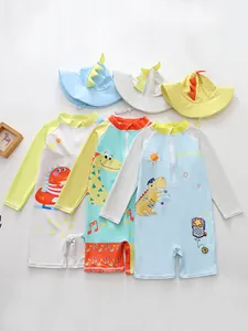 Group view of three boys' dinosaur swimsuits in pastel colors with matching hats