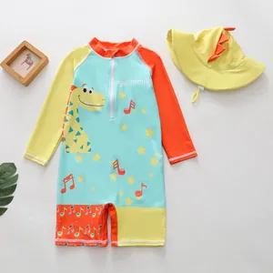 Kids boy one-piece swimsuit set with cartoon dinosaur design and matching yellow sun hat